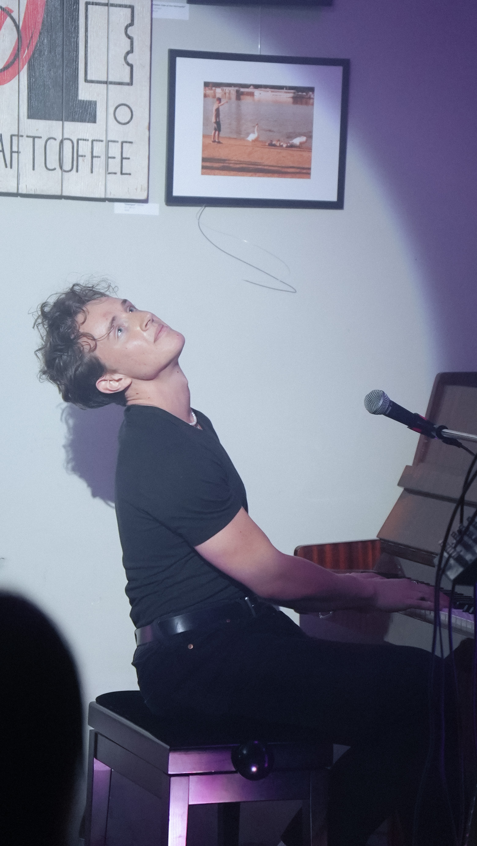 Studio, leaning back at the piano