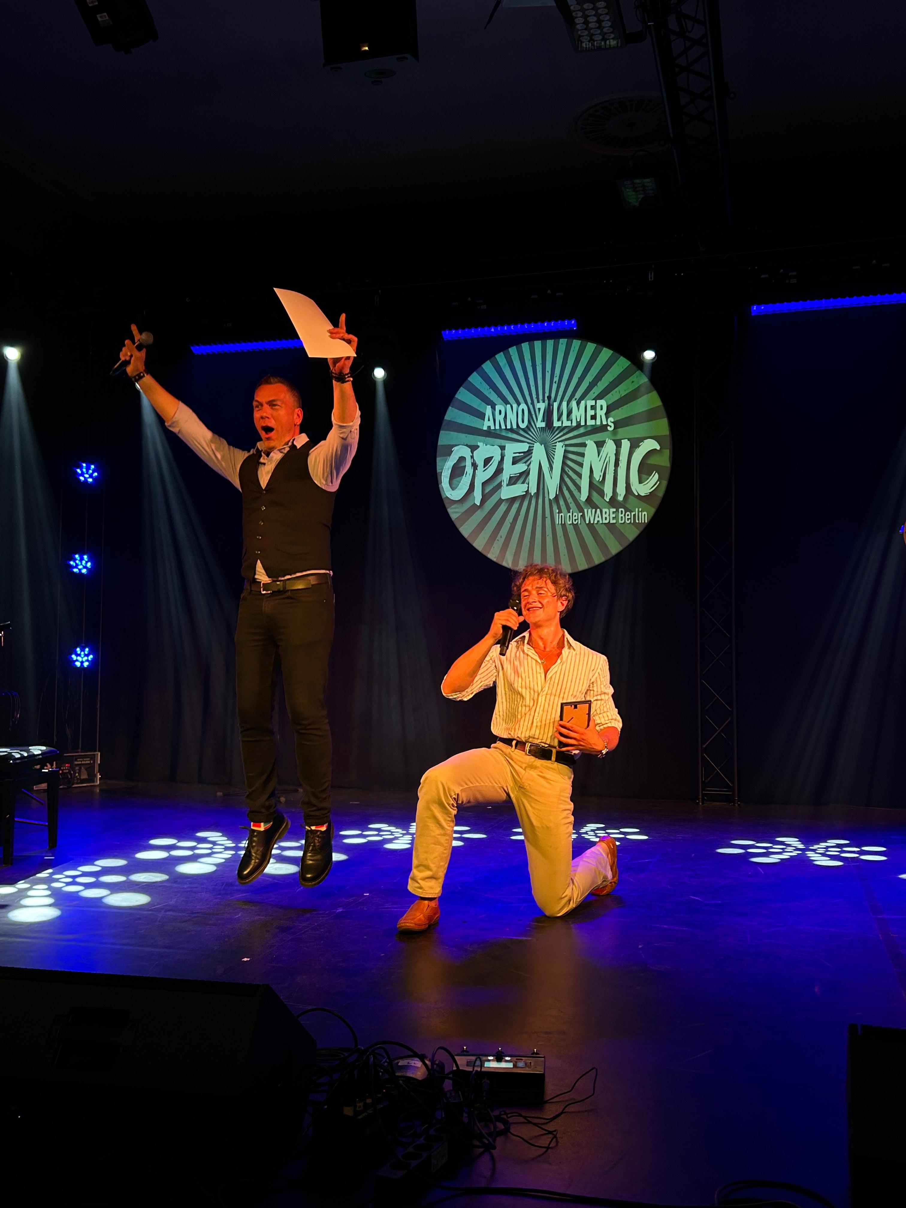 Open mic host, mid-stage leap